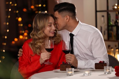 Lovely couple having romantic dinner on Valentine's day in restaurant