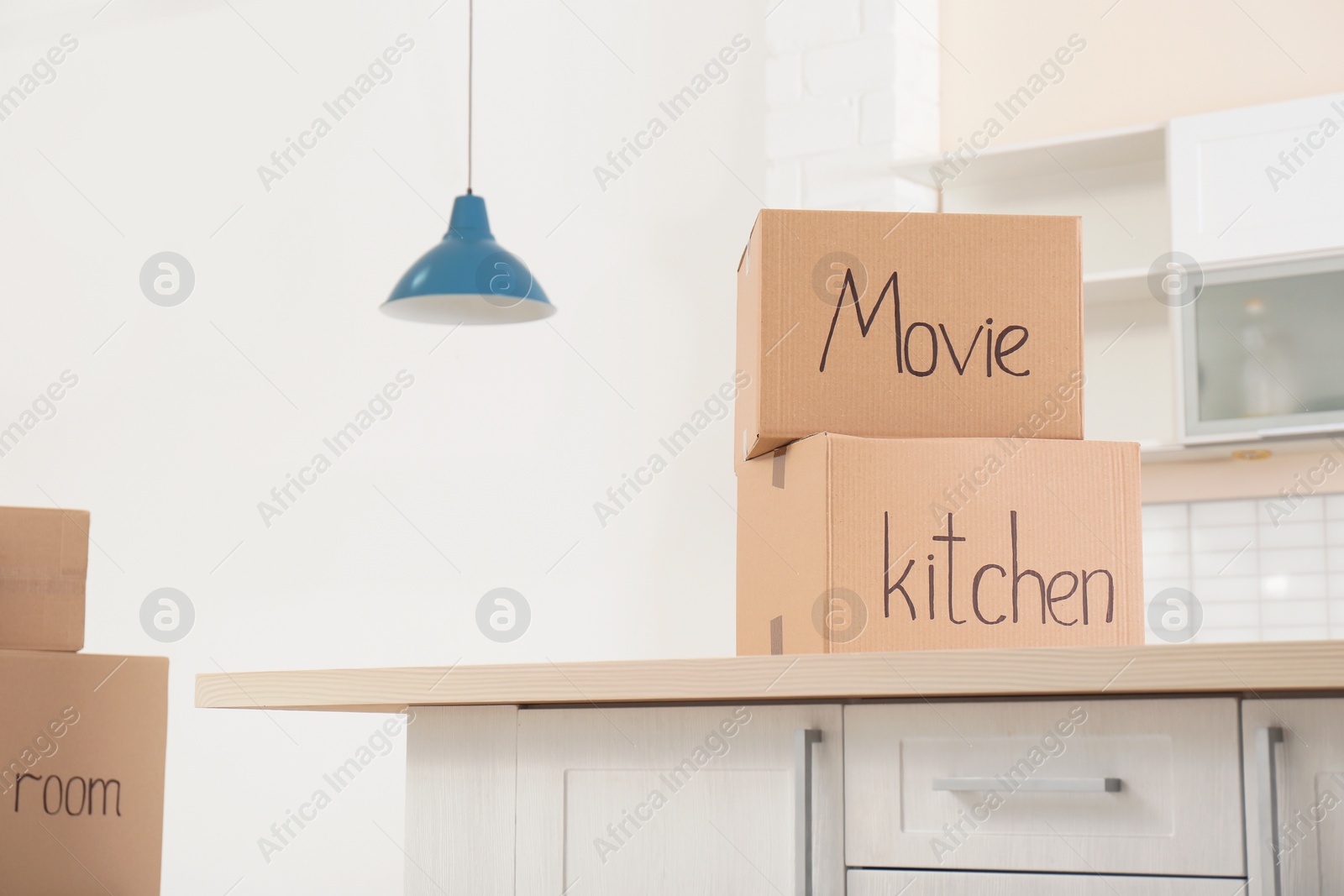 Photo of Moving boxes on table indoors. Space for text