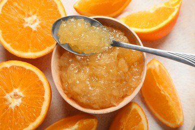 Photo of Bowl of delicious orange jam and fresh fruits on plate, top view