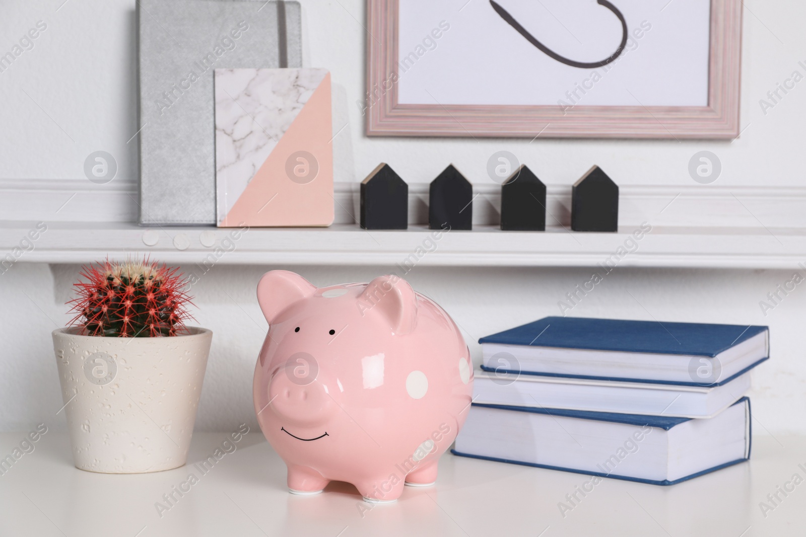 Photo of Color piggy bank on table in room. Cute interior element