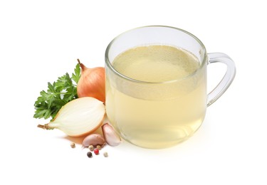 Photo of Hot delicious bouillon in glass cup and ingredients on white background