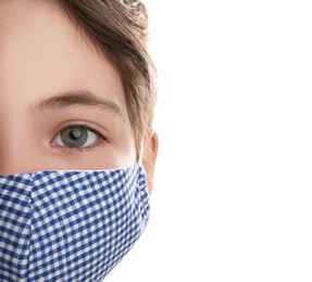 Girl wearing protective mask on white background, closeup. Child's safety from virus