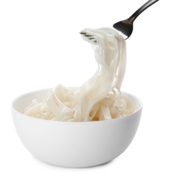 Photo of Taking rice noodles with fork from bowl on white background