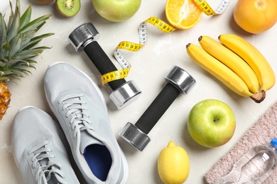 Photo of Flat lay composition with sport items and healthy food on grey background. Weight loss concept