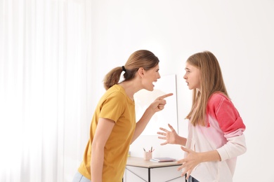 Mother scolding her teenager daughter at home