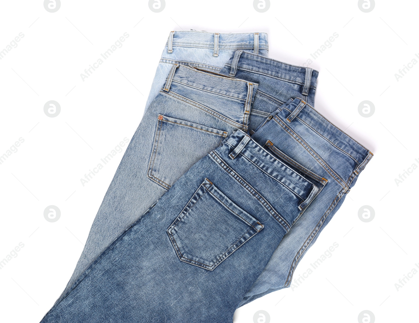 Photo of Different stylish jeans isolated on white, top view