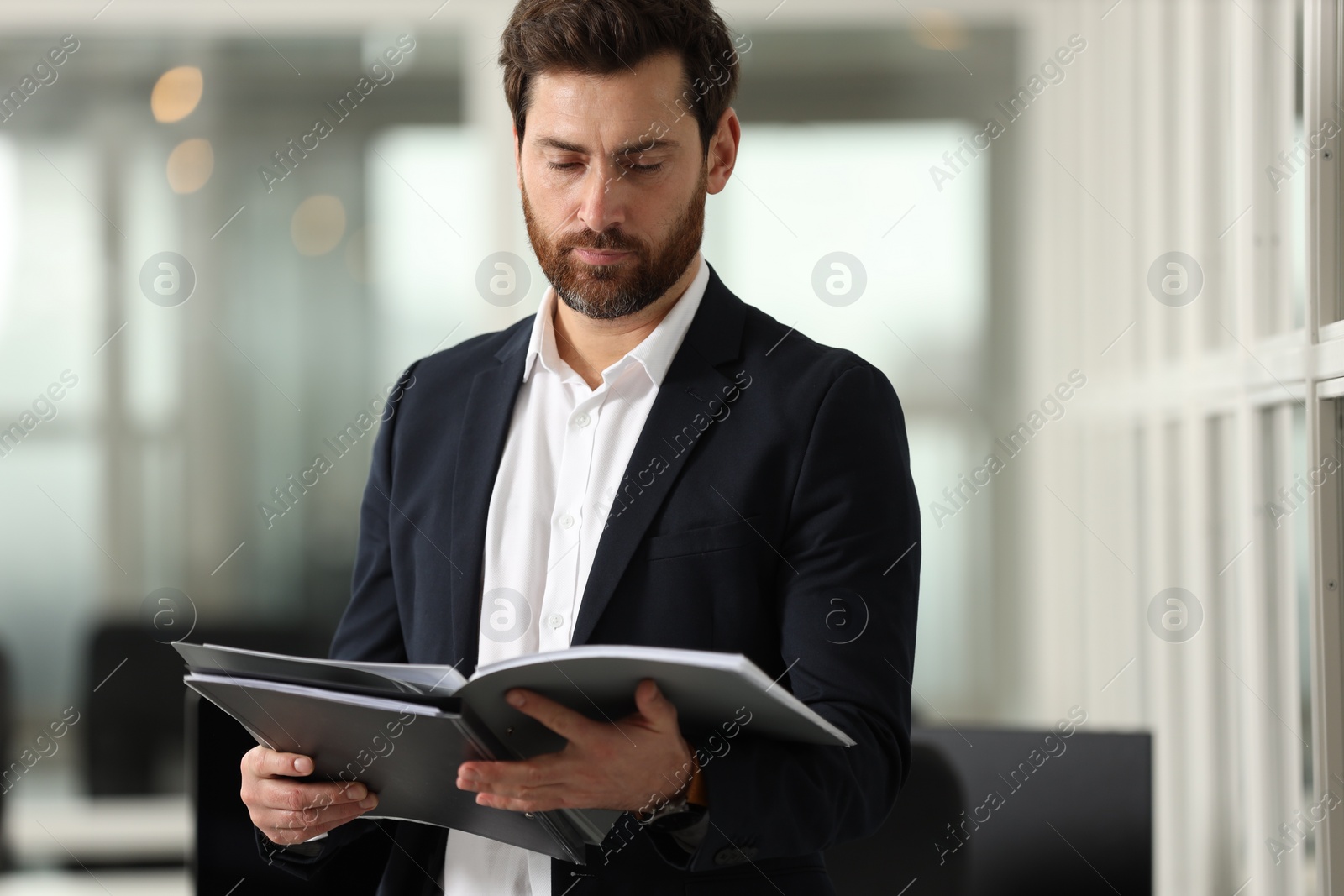 Photo of Handsome man with folder in office. Lawyer, businessman, accountant or manager