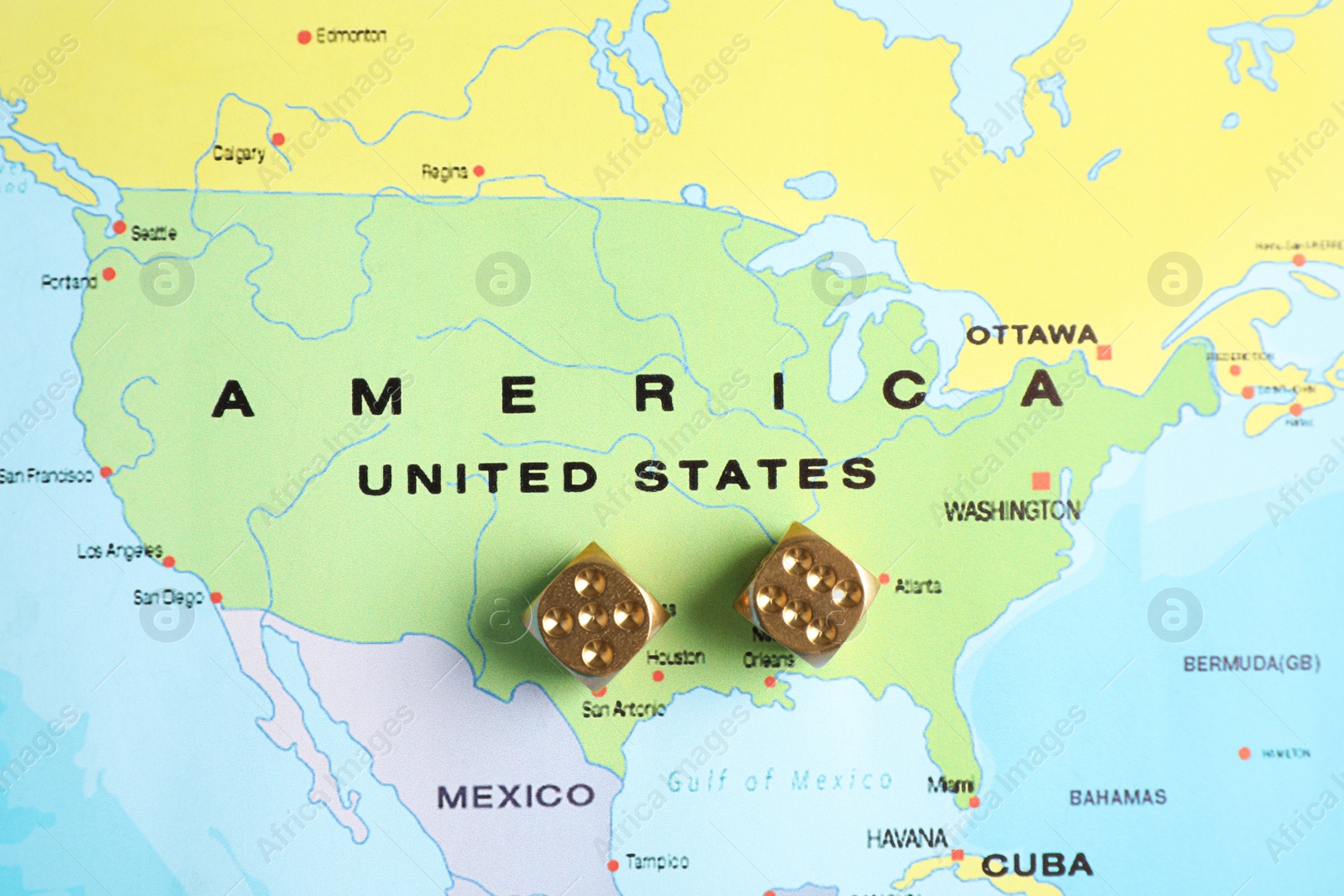 Photo of Gold dices near USA on world map, top view