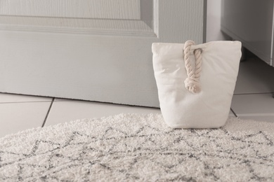 Photo of Stuffed bag holding wooden door at home
