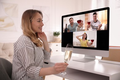 Woman with glass of sparkling wine having online party via computer at home during quarantine lockdown