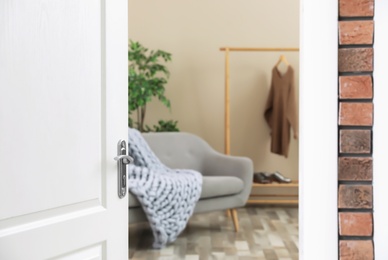 Photo of Stylish room interior, view through open door