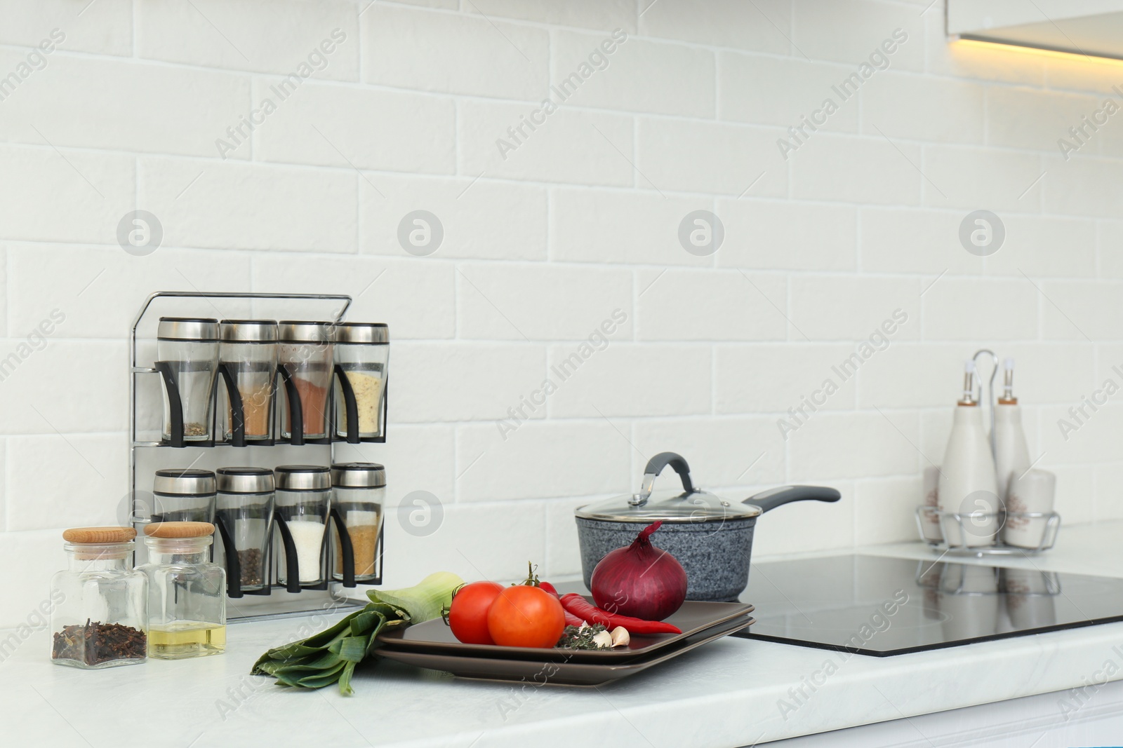 Photo of Fresh vegetables on white countertop in kitchen