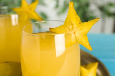 Delicious carambola juice in glass on table, closeup