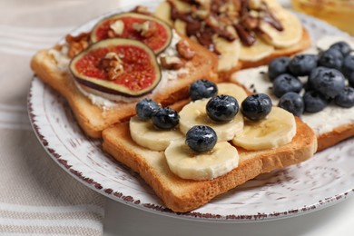 Photo of Different sweet delicious toasts on plate, closeup