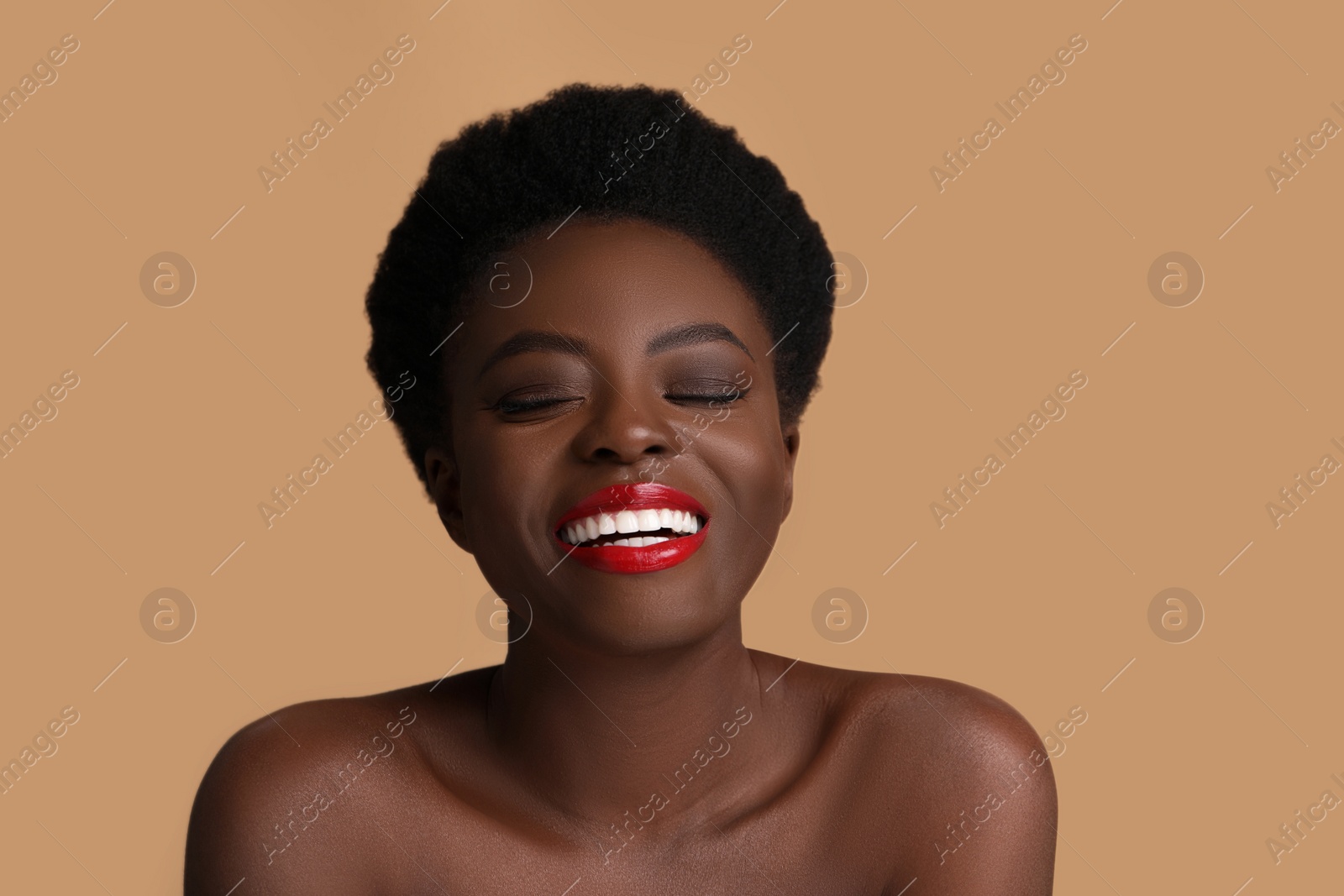 Photo of Portrait of beautiful happy woman on beige background