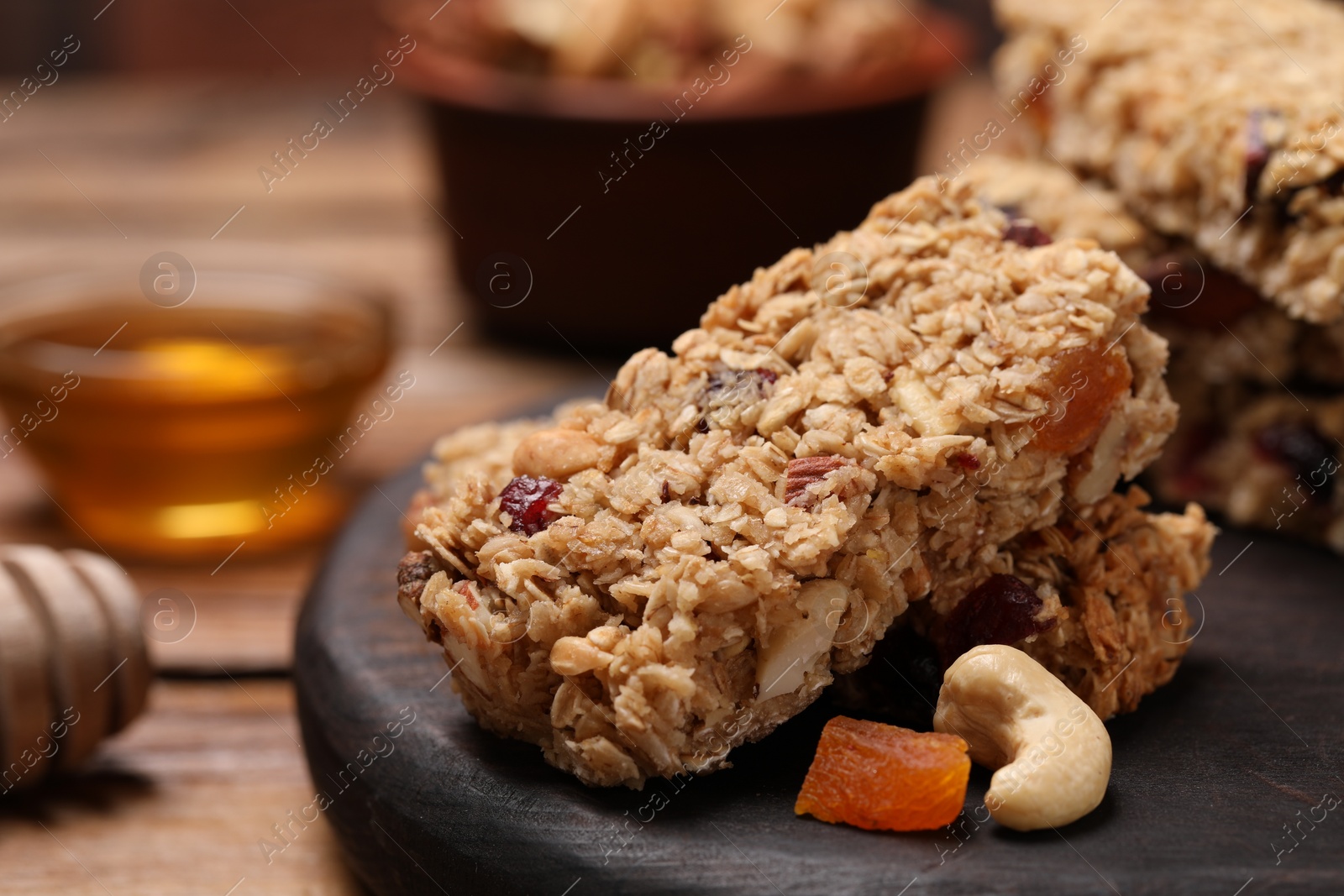 Photo of Tasty granola bars on table, closeup view