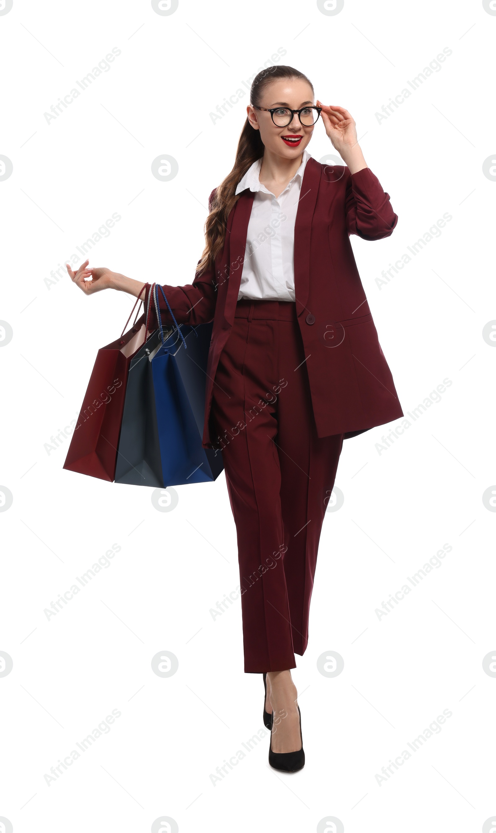 Photo of Stylish young businesswoman with shopping bags on white background