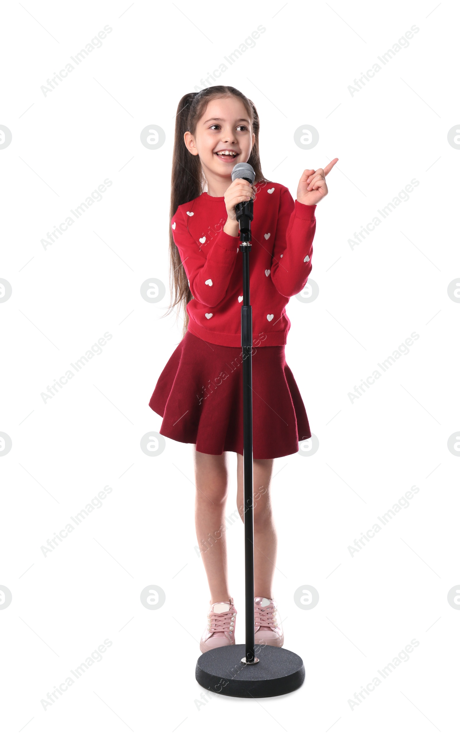 Photo of Little girl singing into microphone on white background