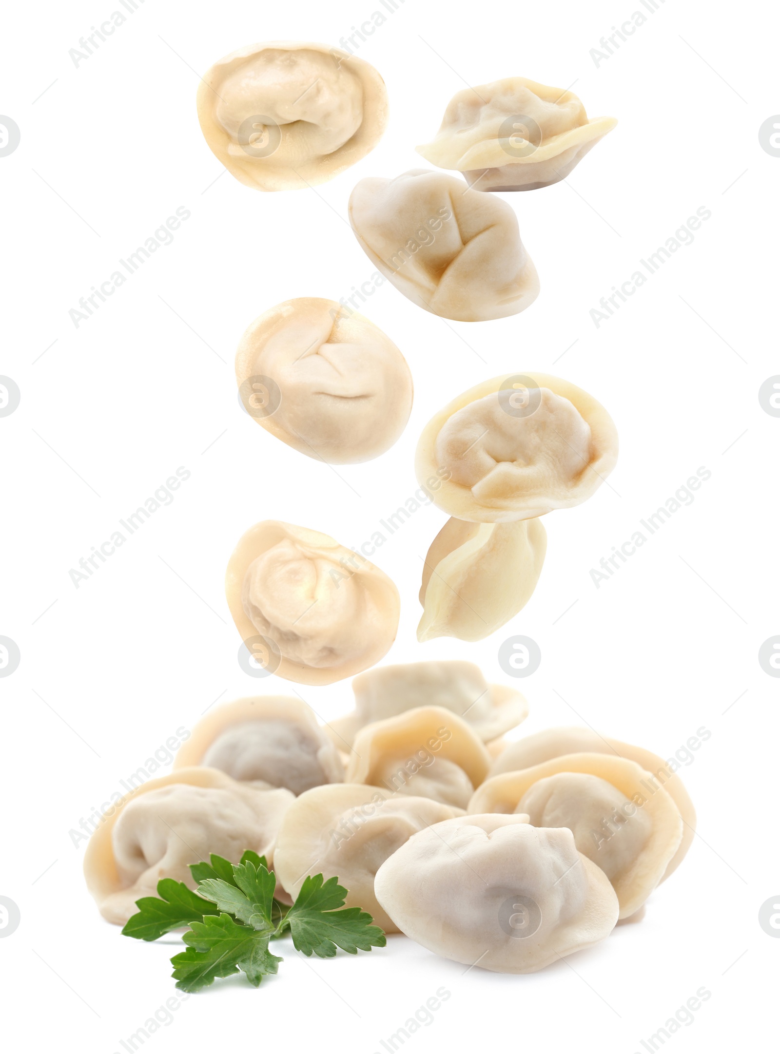 Image of Many tasty dumplings falling on white background