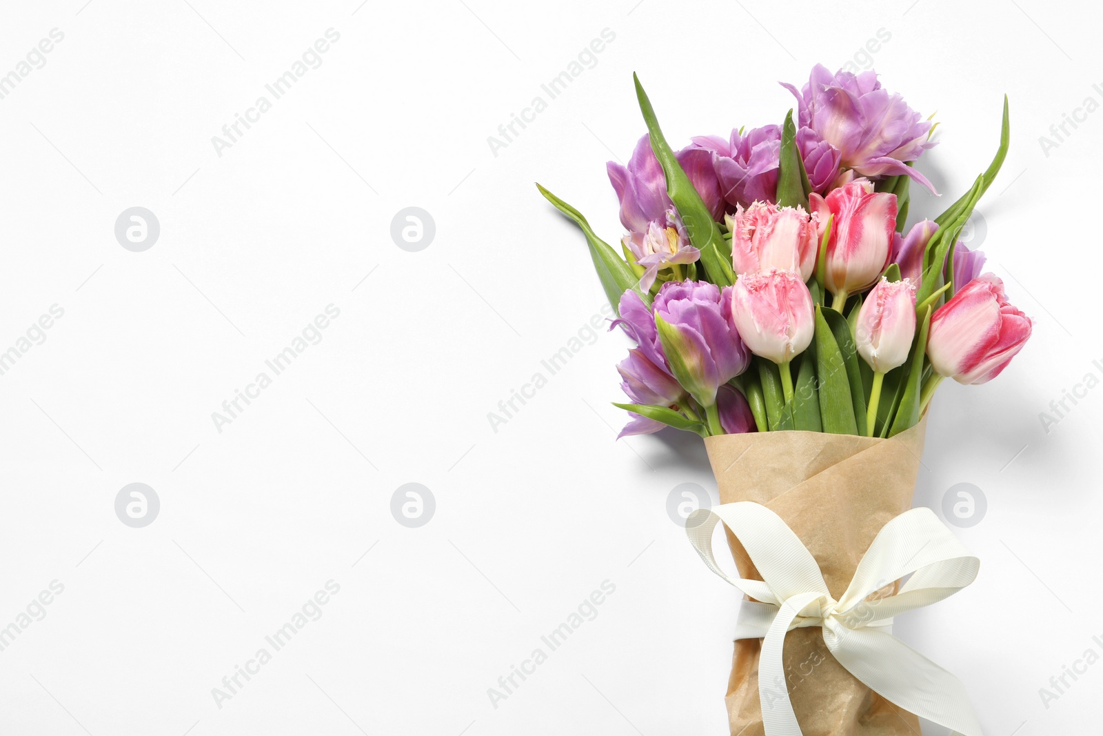 Photo of Beautiful bouquet of colorful tulip flowers on white background, top view. Space for text