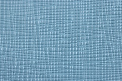 Light blue leather as background, top view