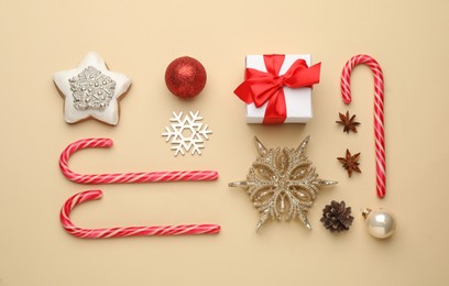 Flat lay composition with sweet candy canes and Christmas decor on beige background