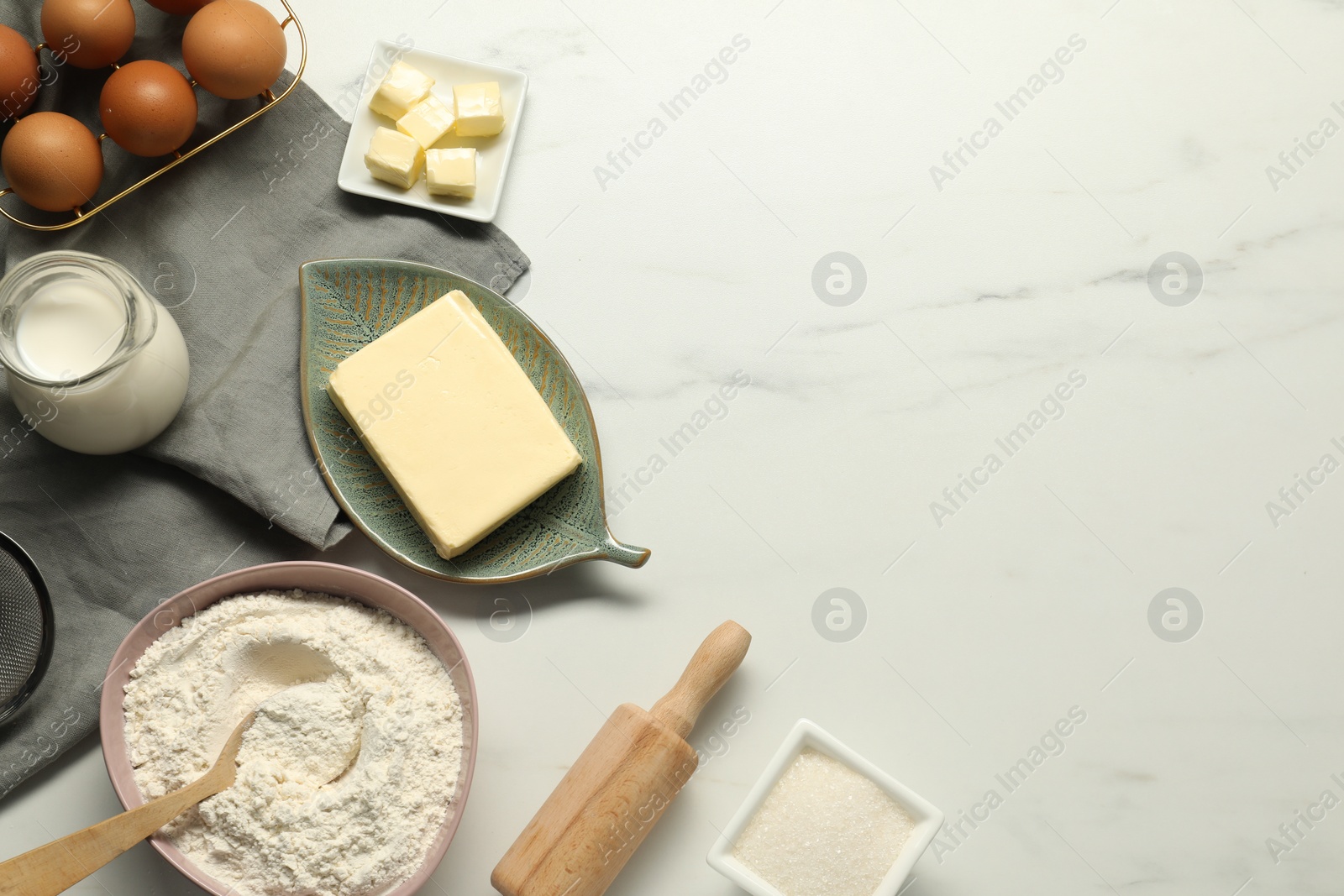 Photo of Flat lay composition with fresh butter among other products on white marble table. Space for text