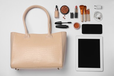 Flat lay composition with stylish woman's bag on light background