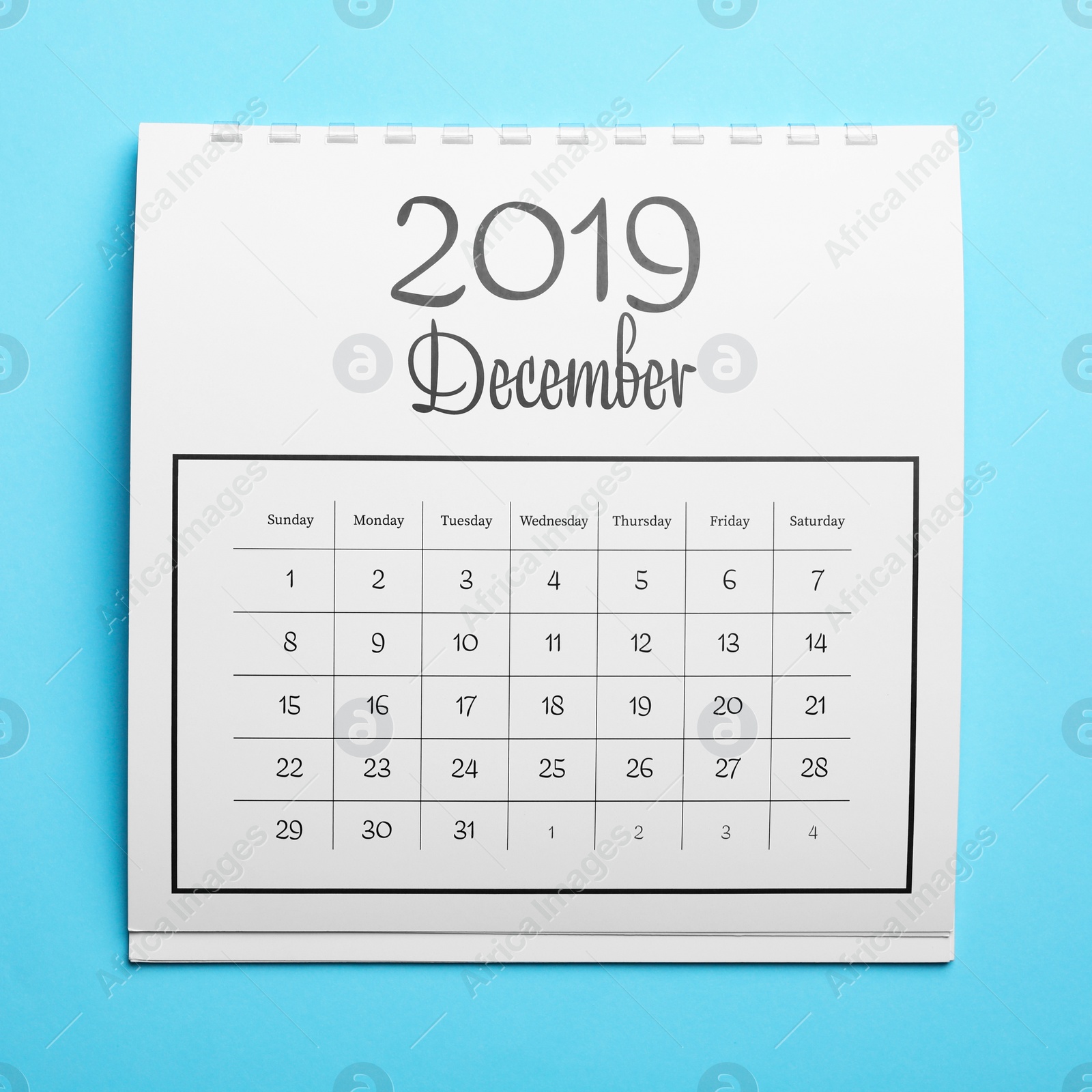 Photo of December 2019 calendar on light blue background, top view