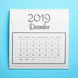 Photo of December 2019 calendar on light blue background, top view