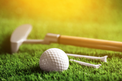Image of Set of golf equipment in park on sunny day