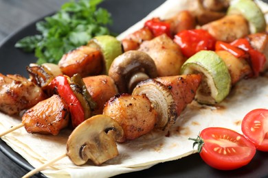 Photo of Delicious shish kebabs with vegetables on table, closeup