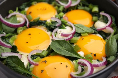 Photo of Tasty green Shakshouka in frying pan, closeup