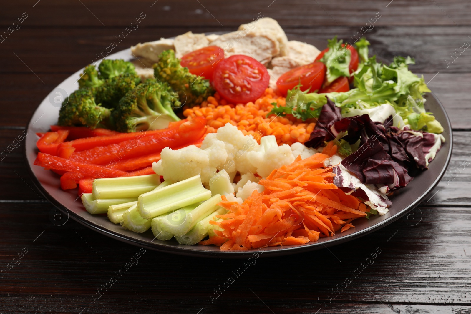 Photo of Balanced diet and healthy foods. Plate with different delicious products on dark wooden table, closeup