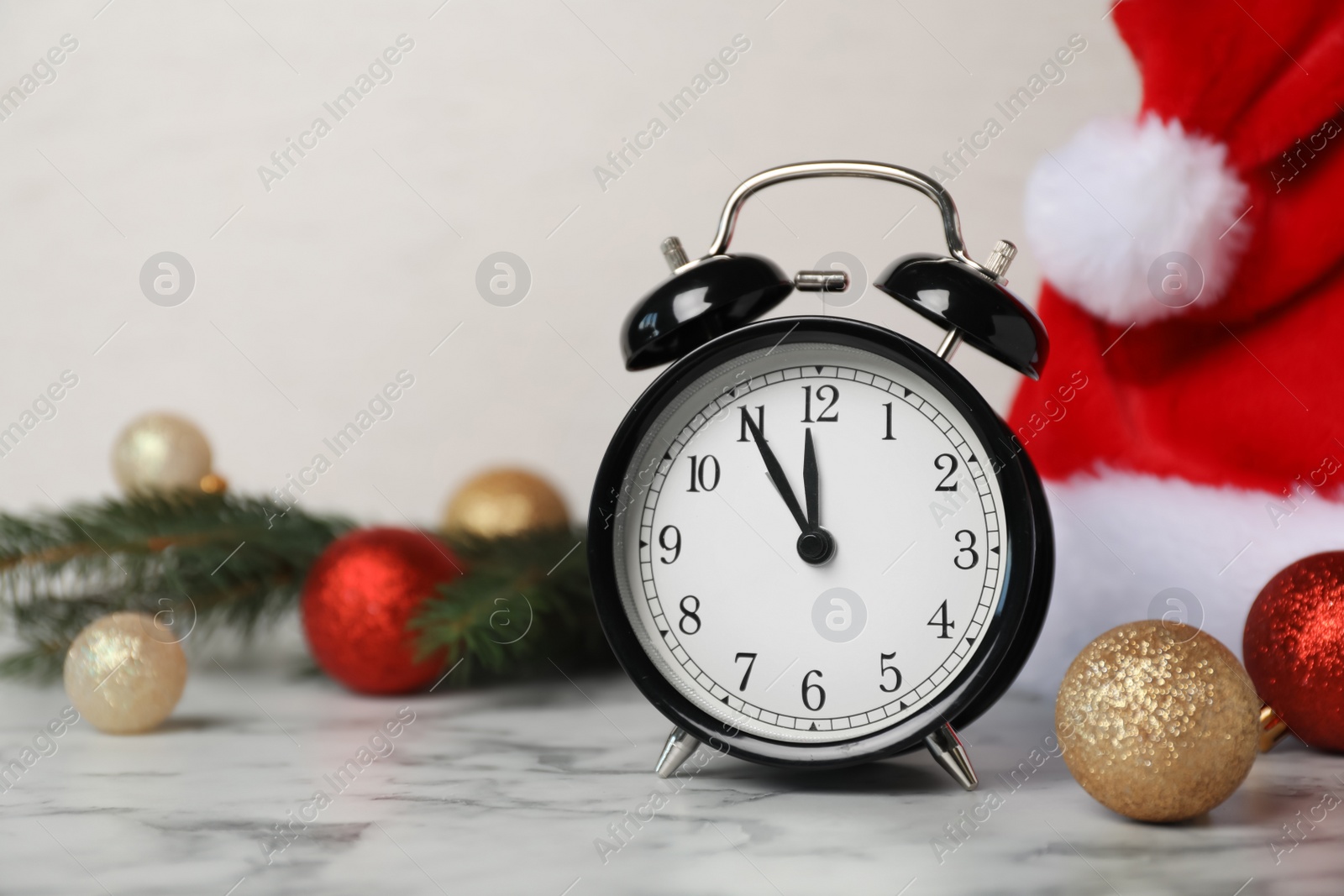 Photo of Alarm clock and festive decor on table. Christmas countdown