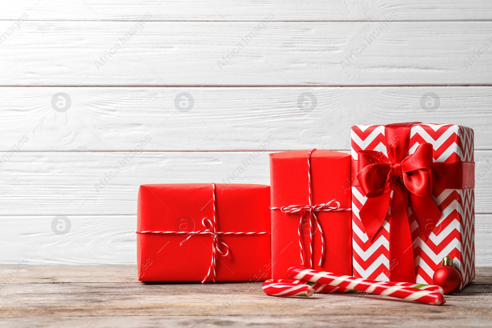 Photo of Beautiful composition with Christmas gift boxes on wooden table