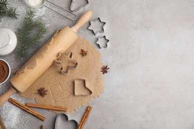 Photo of Homemade Christmas cookies. Flat lay composition with dough on light grey table, space for text