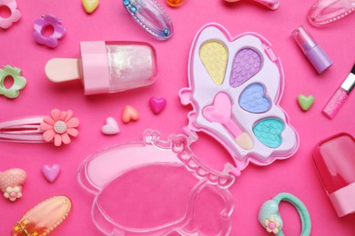 Photo of Children's kit of makeup products and accessories on pink background, flat lay