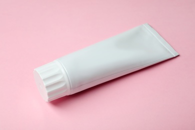 Photo of Blank tube of toothpaste on color background