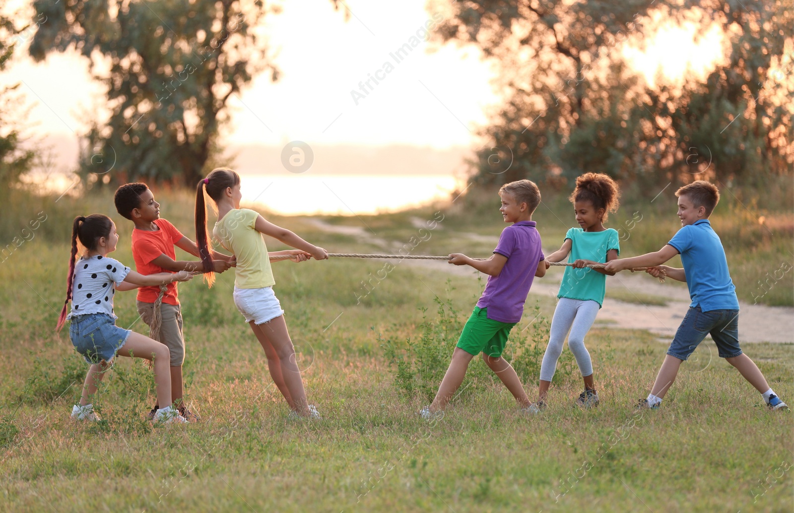 Photo of Cute little children playing outdoors at sunset