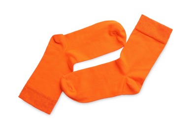 Pair of orange socks on white background, top view