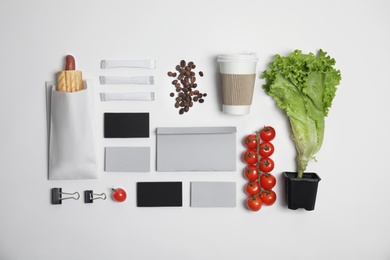 Photo of Flat lay composition with items for mock up design on light background. Food delivery service