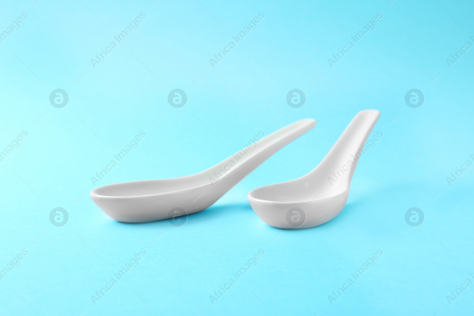 Photo of Clean Miso soup spoons on blue background