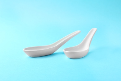 Photo of Clean Miso soup spoons on blue background