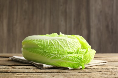 Photo of Fresh ripe Chinese cabbage on wooden table