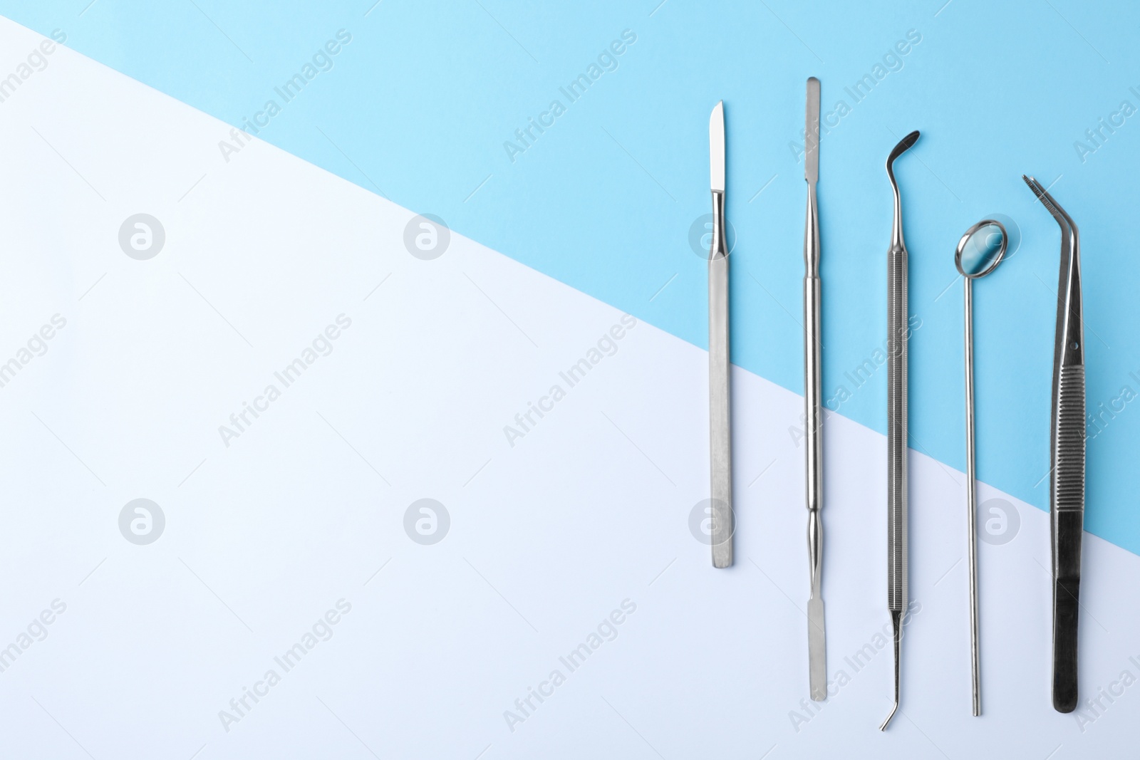 Photo of Set of different dentist tools on color background, flat lay. Space for text