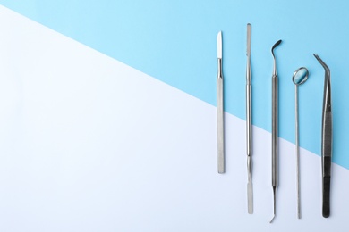 Set of different dentist tools on color background, flat lay. Space for text