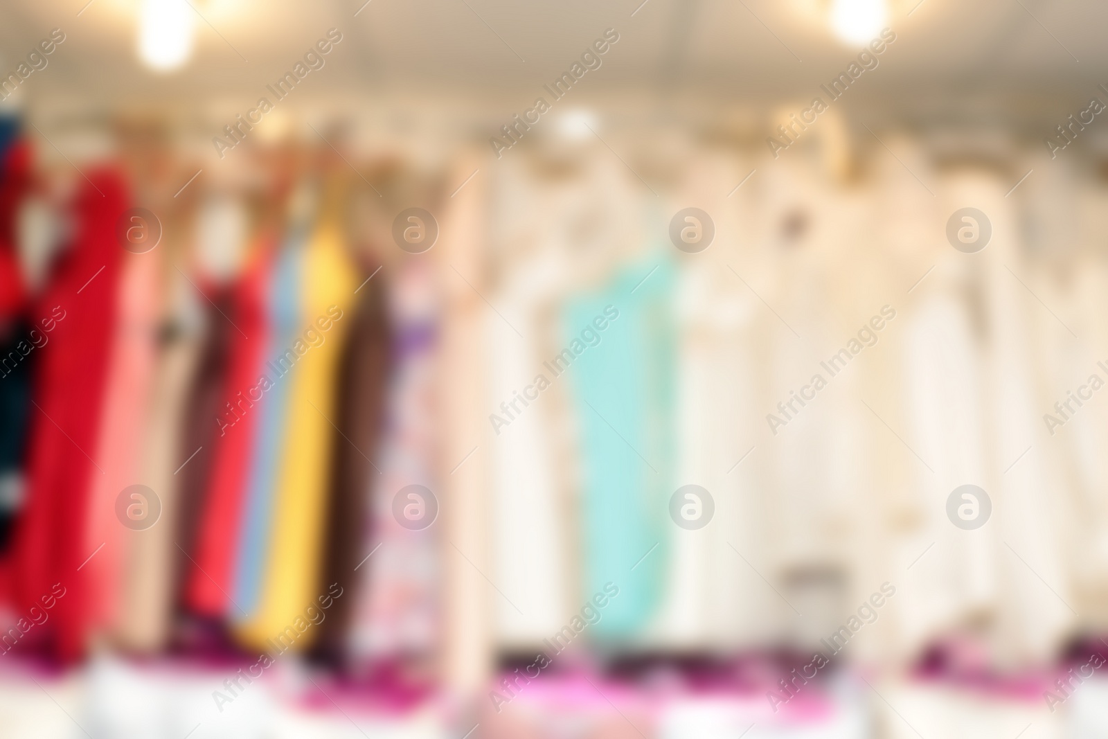 Photo of Blurred view of female nighties on hangers in underwear shop