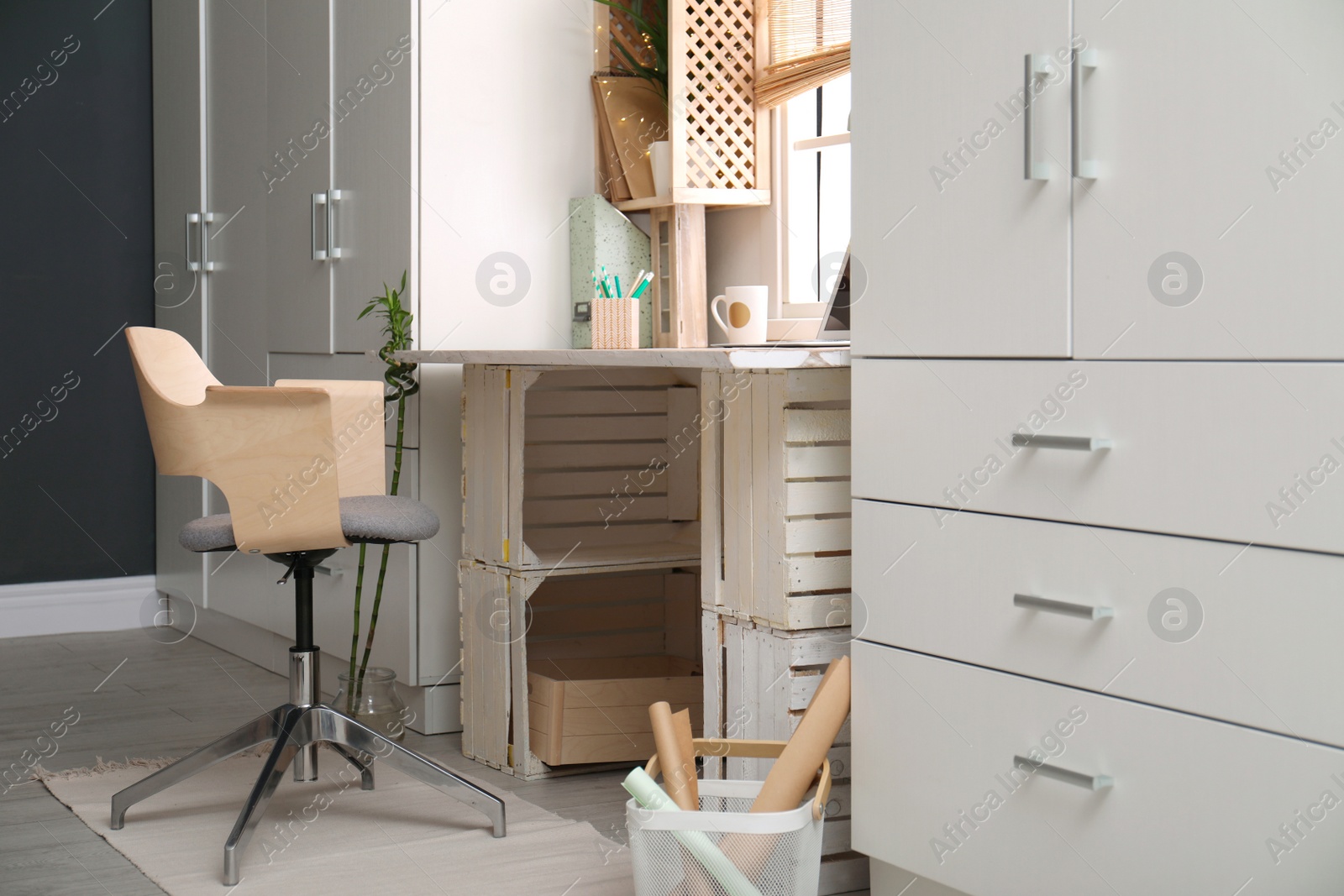 Photo of Modern home workplace with wooden crates. Eco style interior