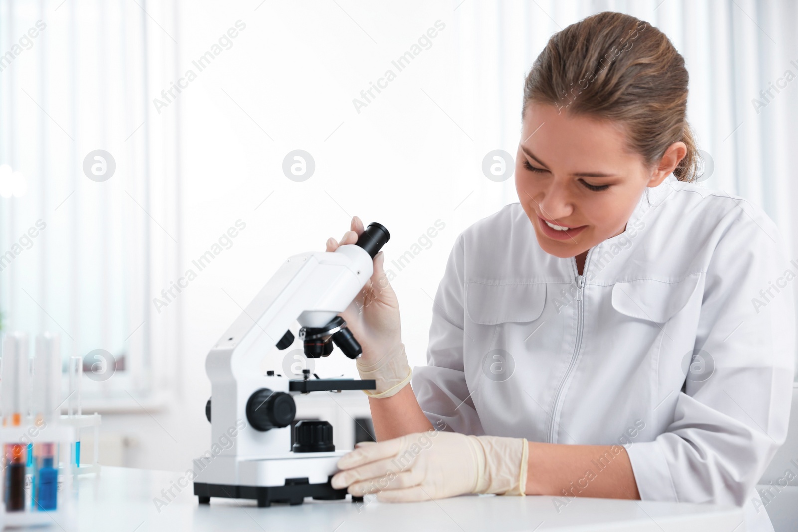 Photo of Scientist with modern microscope at table. Medical research